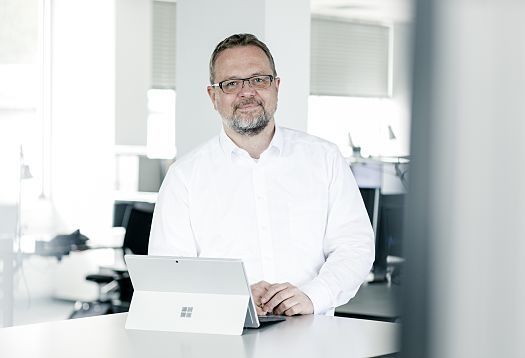 ERCO employee with a tablet in the office, focused on lighting design and innovative lighting solutions.