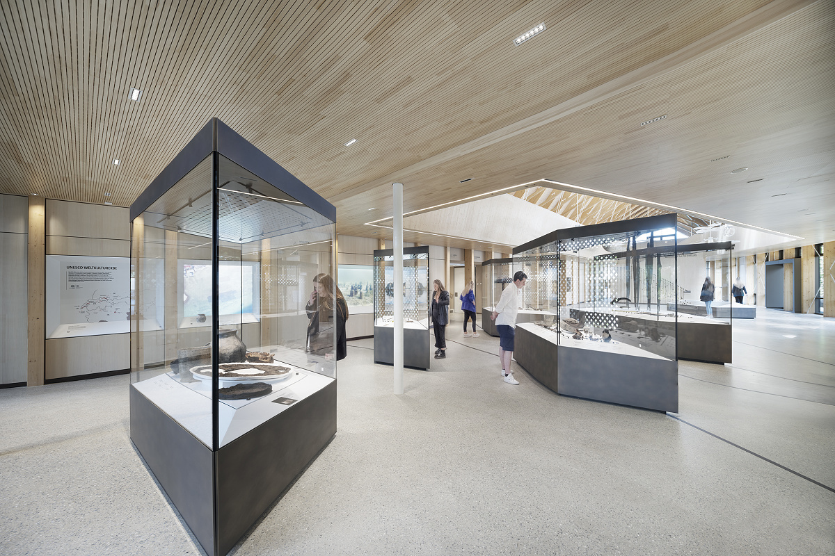 Interior of Pfahlbaumuseum Unteruhldingen featuring exhibits in display cases and ERCO lighting.