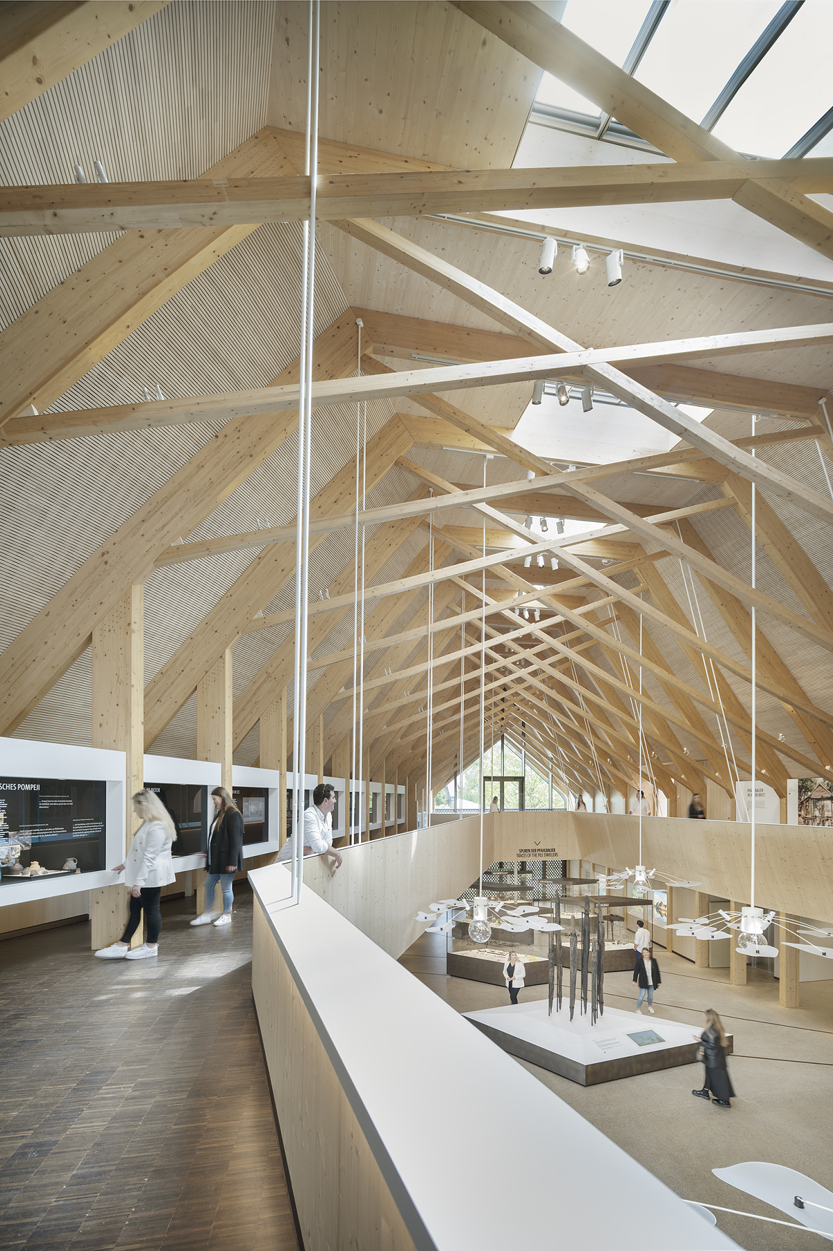 Pfahlbaumuseum Unteruhldingen interior featuring ERCO lighting and striking wood construction.