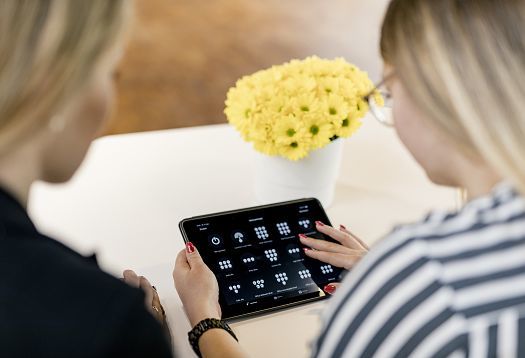ERCO sales professionals using a tablet for lighting control and planning.