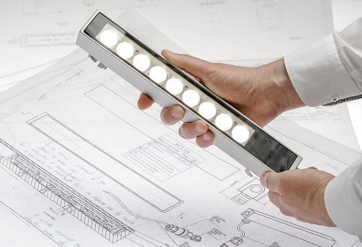 ERCO lighting tool in hand, used for planning lighting projects.