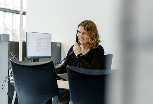 ERCO sales professional in conversation with clients on the phone.
