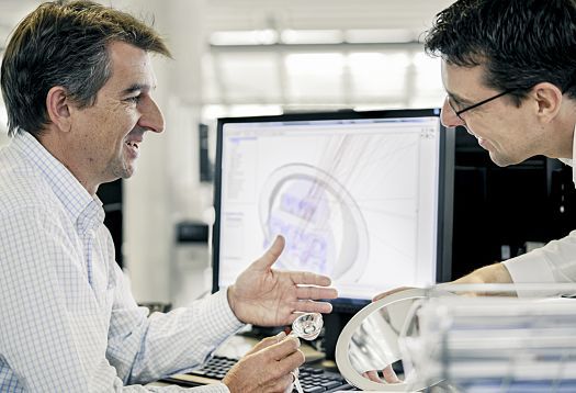 ERCO professionals collaborate on lighting design using CAD software for innovative lighting solutions.