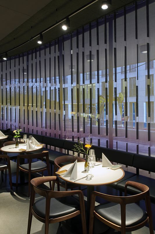 Restaurant at Schauspielhaus Düsseldorf with ERCO LED lighting and set tables.