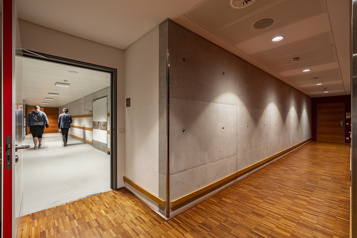 Hallway in Ferry Porsche Congress Center illuminated by energy-efficient ERCO LED downlights.