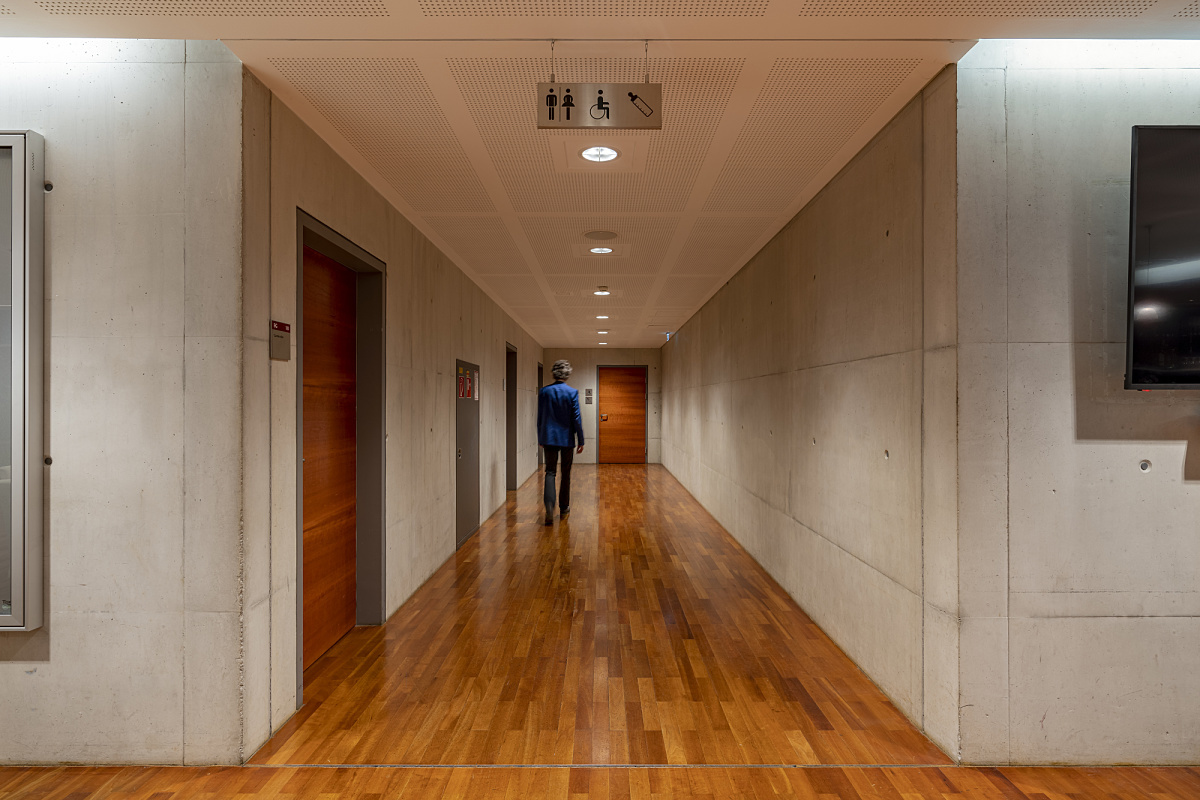 Hallway in Ferry Porsche Congress Center lit by energy-efficient ERCO LED downlights.