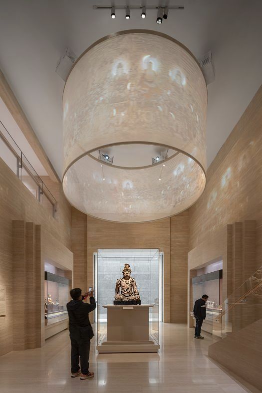 Shanghai Museum Easts Bronze Gallery featuring a Buddha statue illuminated by ERCO LED spotlights.