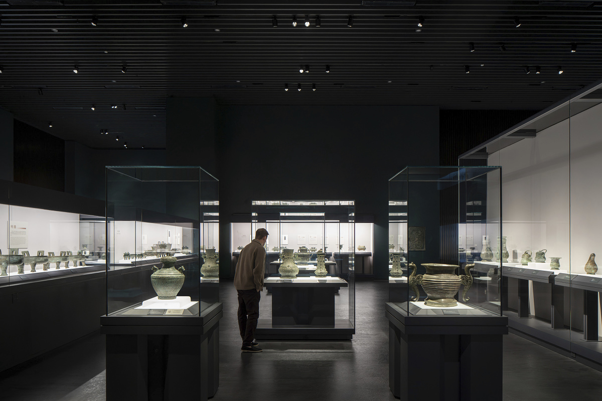 Shanghai Museum East's Bronze Gallery, showcasing artifacts with ERCO spotlight illumination.