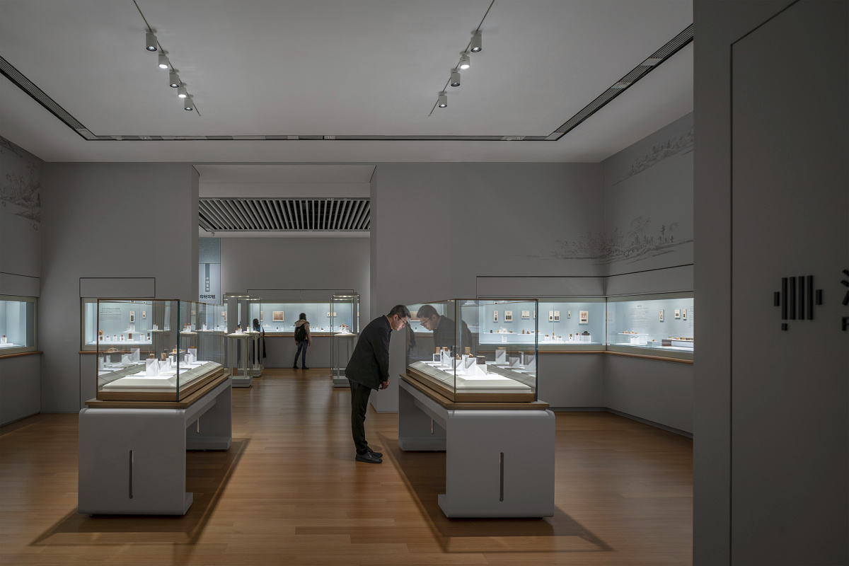 Visitor views art in Shanghai Museum East's Jiangnan Gallery, illuminated by ERCO spotlights.