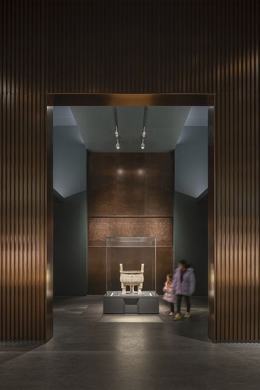 Illuminated bronze vessel at Shanghai Museum East, showcased with ERCO spotlights for optimal detail.