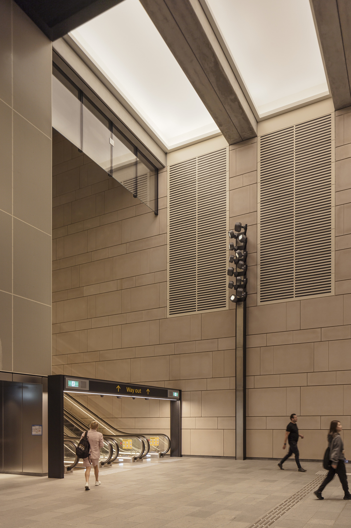 ERCO Kona LED lighting illuminates Waterloo Metro Station, Sydney, featuring art installations and urban design.