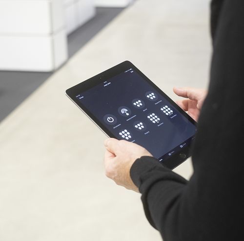 Tablet controlling ERCO 48V lighting, showcasing flexible light management via app.