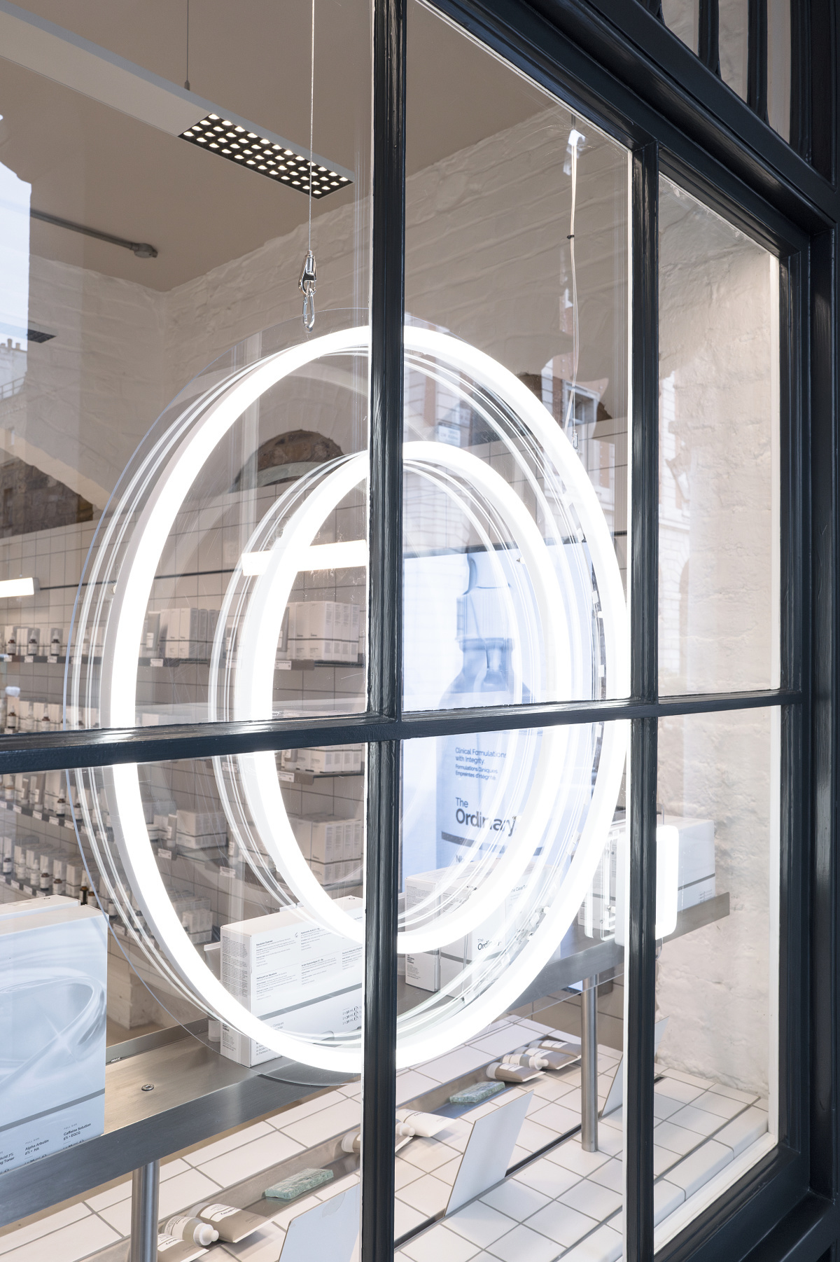 The Ordinarys Covent Garden storefront featuring circular LED lighting design.