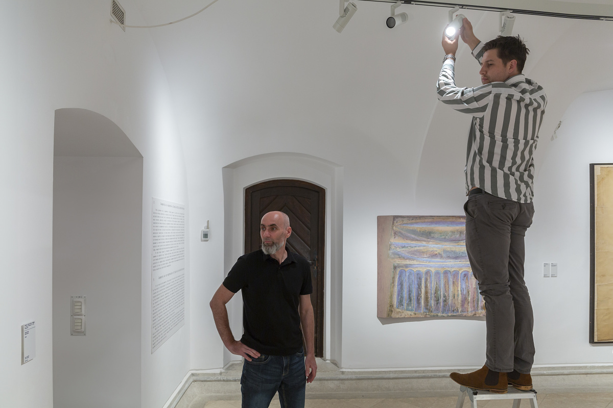 ERCO Eclipse spotlights being adjusted for flexible exhibition lighting at Timisoara Art Museum.