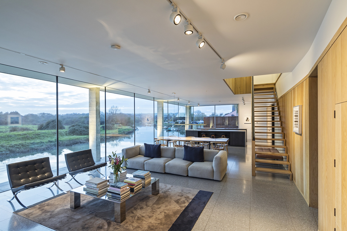 ERCO track lights illuminate a modern living room, offering flexible lighting design.