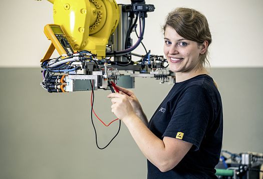 ERCO trainee working on a robot as part of vocational training.
