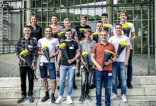 ERCO apprentices and dual students with school cones in front of the company building.