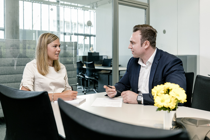 ERCO employees in discussion during work in a modern office.