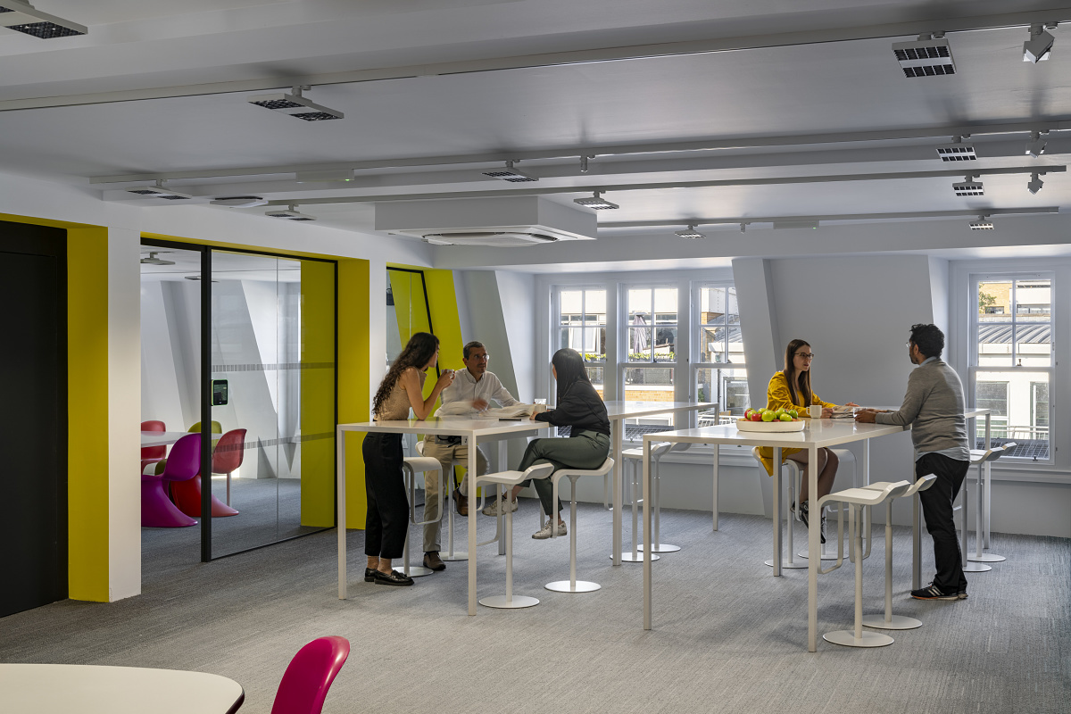 ERCO Jilly downlights in a modern Zaha Hadid office, supporting staff wellbeing.