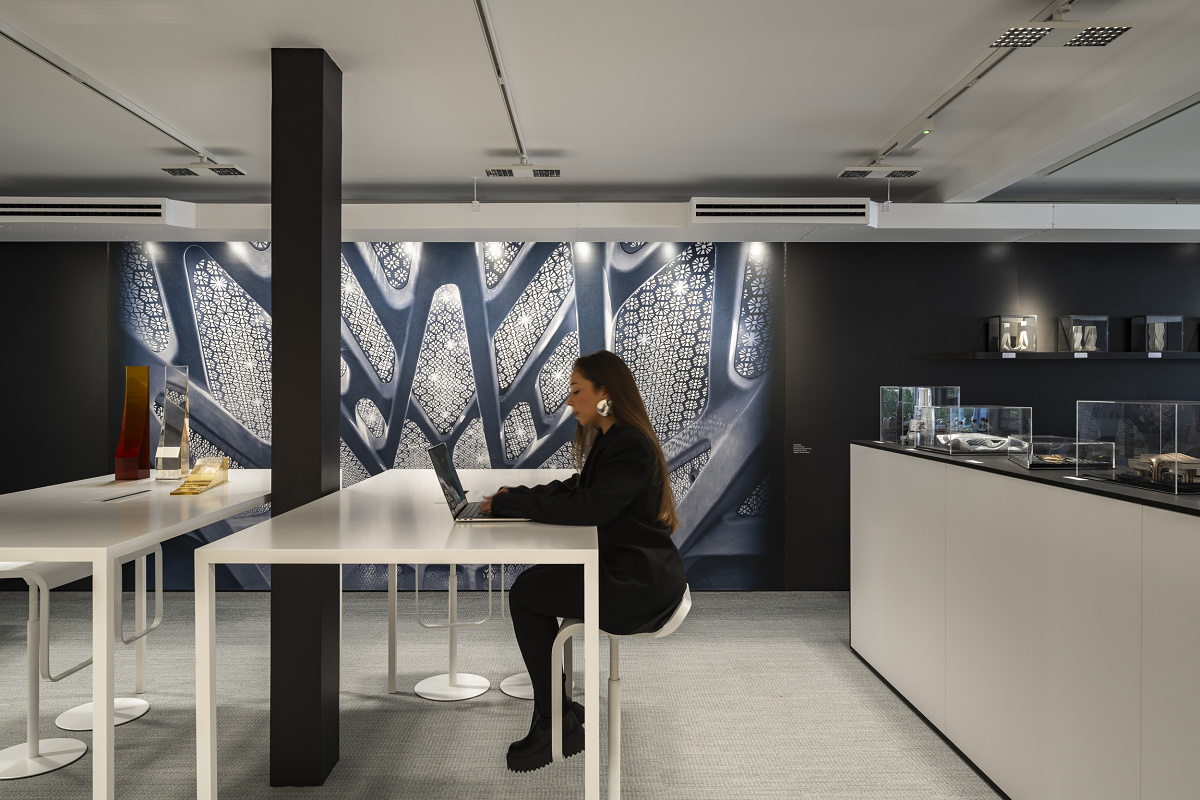 ERCO lighting at Zaha Hadid: Staff working on a laptop in a modern, well-lit office space.