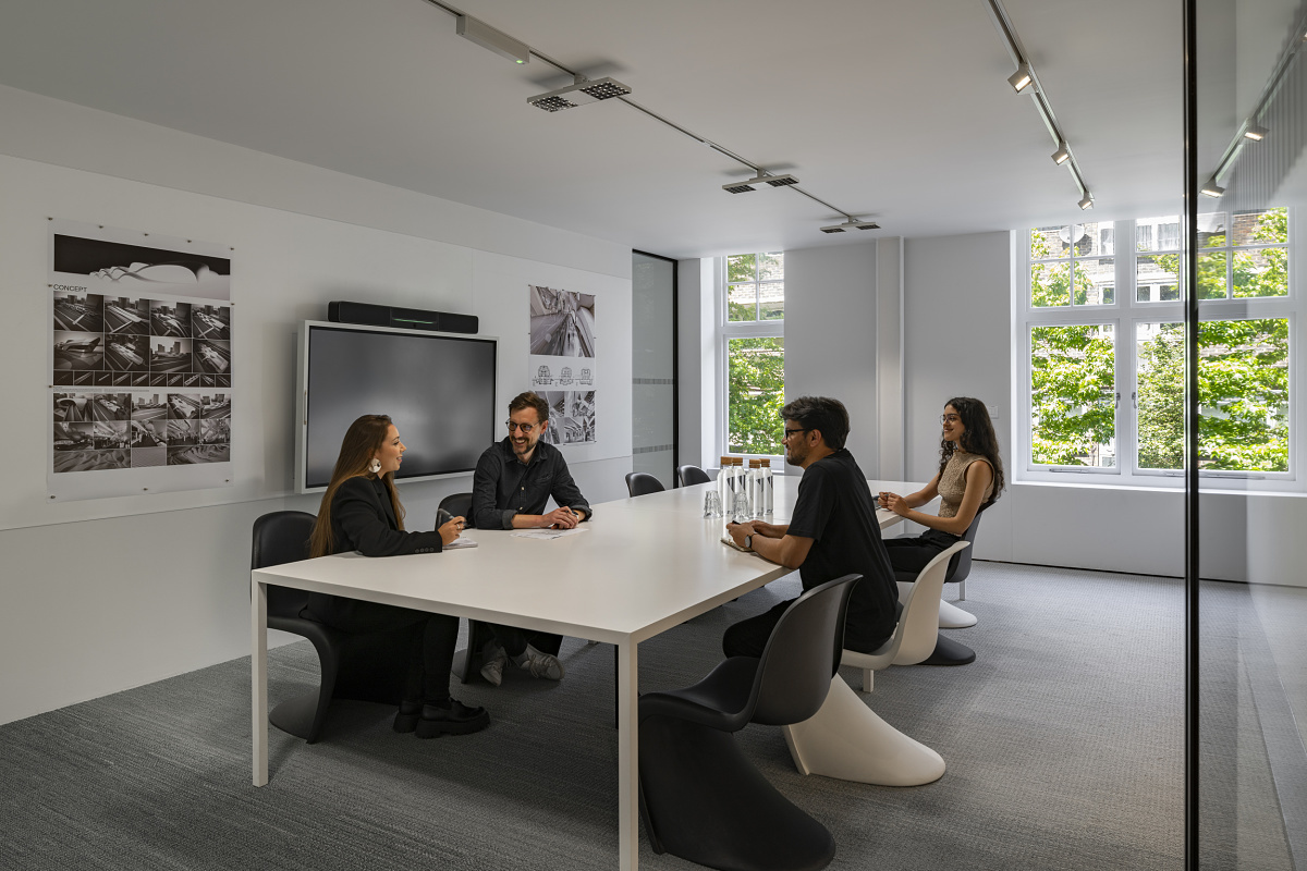 Meeting at Zaha Hadid's London office, featuring ERCO lighting for modern design and well-being.