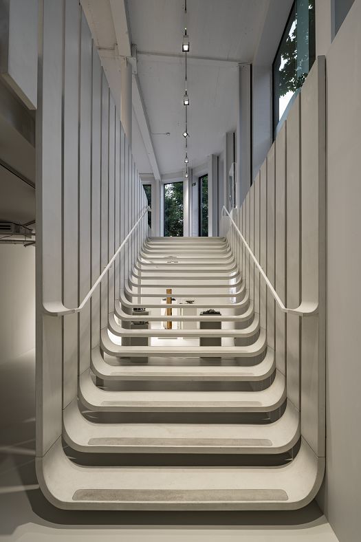 Stairwell with ERCO lighting at Zaha Hadids London office, showcasing modern design and staff wellbeing.
