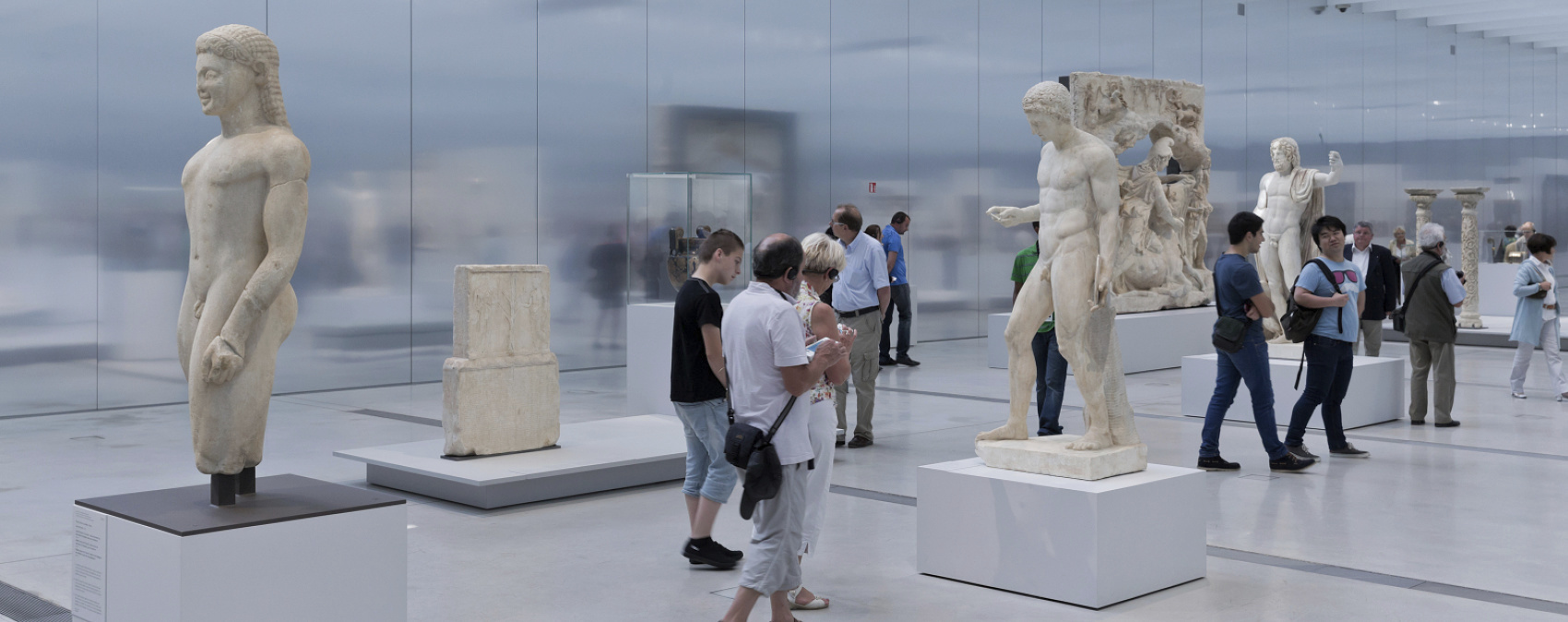 Museum exhibit featuring ancient sculptures illuminated by ERCO lighting.